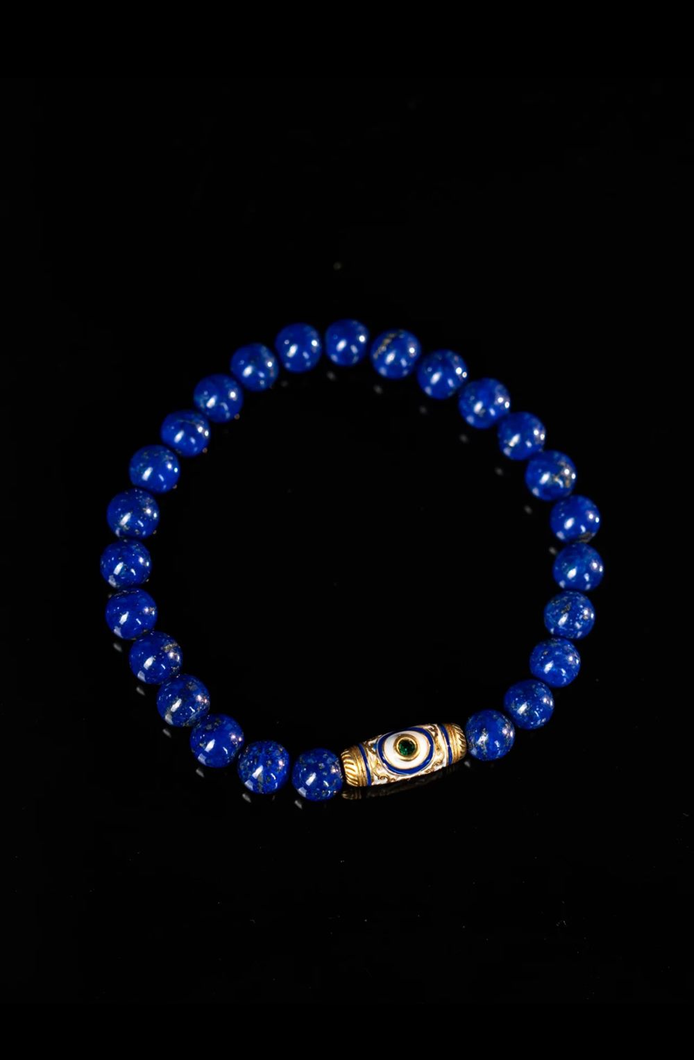 Deep Blue Lapis Bracelet with Dzi-Style Focal Bead in scene